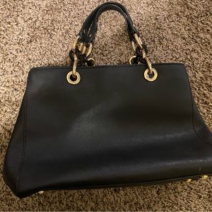 Michael Kors black and gold purse. Hardly used and in new condition.